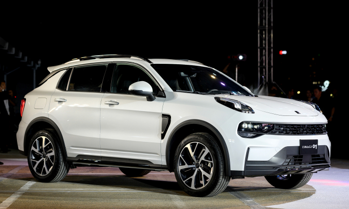 Xe SUV Lynk & Co 01 màu trắng nổi bật dưới ánh đèn tại sự kiện trưng bày